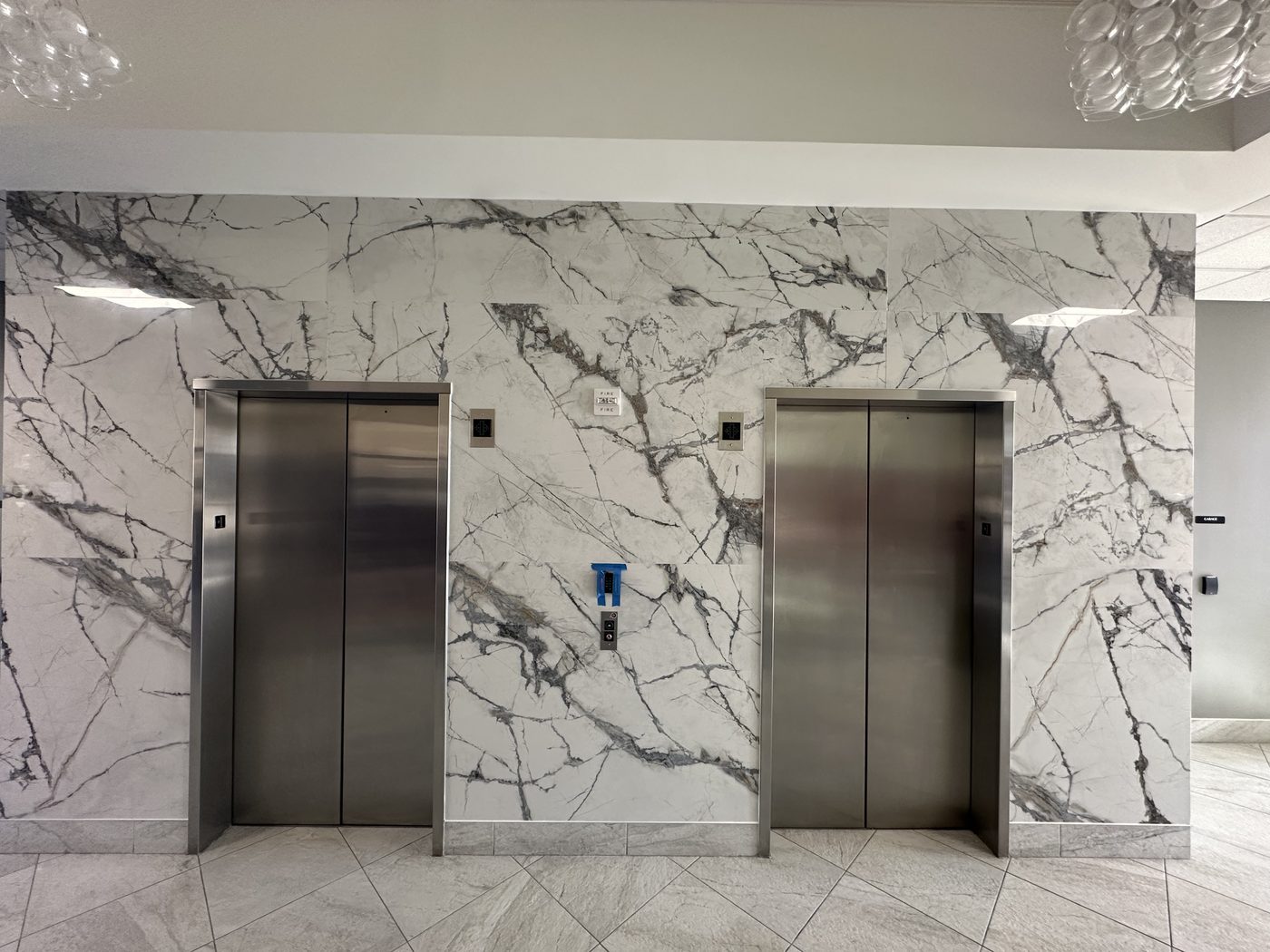 Commercial lobby with marble-clad elevator walls